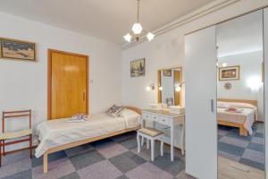a bedroom with two beds and a sink and a mirror at Apartment Complex Nevia in Poreč