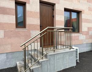 a set of stairs next to a building with a door at Elegant and cozy room ARAKS in Kostinbrod