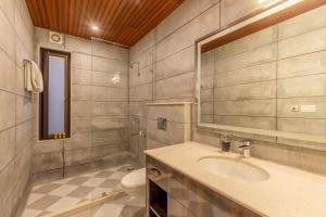 a bathroom with a sink and a toilet at The Manor Luxury Apartments, Shimla in Nāldera