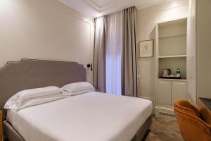 Postel nebo postele na pokoji v ubytování Hotel Smeraldo