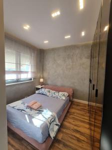 a bedroom with a large bed in a room at Lavender Beach House in Durrës