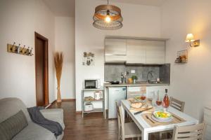 a kitchen with a table and a dining room at Fornaci Vatican Flat in Rome