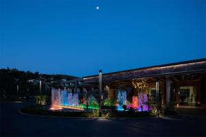 a building with a fountain in front of it at night at Vogue Hotel Supreme Bodrum in Torba