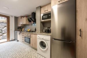 a kitchen with a stainless steel refrigerator and a dishwasher at CAN ROC in Camprodon