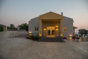 a small building with a door on a brick road at Fournia Village in Kyllini