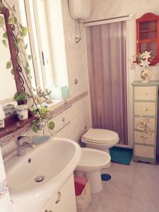 a bathroom with a sink and a toilet at Amazing Roof in the heart of Naples! in Naples