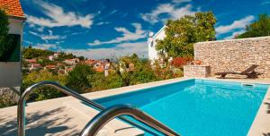 a swimming pool with a view of a house at Villa Lorena in Sutivan