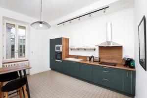 a kitchen with green cabinets and a counter top at La Pittoresque 1 in Carcassonne