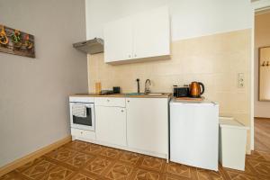 a kitchen with white cabinets and a sink at FullHouse - Görlitz - B7 Bruno - 3 Bedrooms - SmartTV - Nespresso in Görlitz +20 photos