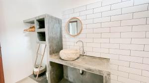 a bathroom with a sink and a mirror at The Kumpi Bali by The Lavana in Canggu +34 photos
