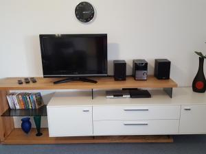 a flat screen tv sitting on top of a white entertainment center at Haus Fernblick in Badenweiler