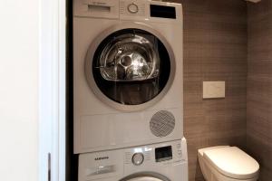 a washing machine and a washer in a bathroom at #9 Opera's Duplex panoramic Sea View Terrace & AC 1min to Beach in Nice