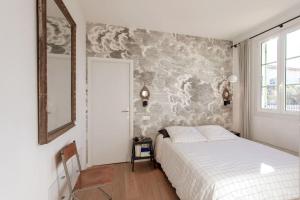 sypialnia z łóżkiem i malowidłem ściennym w obiekcie #9 Opera's Duplex panoramic Sea View Terrace & AC 1min to Beach w Nicei