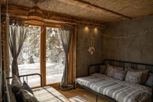 a bedroom with a bed in front of a window at Górna Chata Mountains Chalet - Stable Cottage in Ochotnica Górna