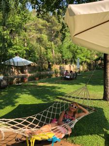 a woman sitting in a hammock in a park at Dalya Life in Göcek