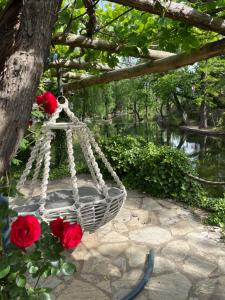 a white rope swing with red roses on it at Dalya Life in Göcek