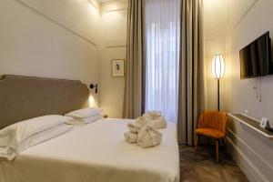 Postel nebo postele na pokoji v ubytování Hotel Smeraldo