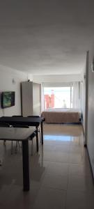 a room with a ping pong table and a bed at Departamento in Puerto Madryn