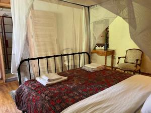 a bedroom with a bed with two towels on it at La Locanda in Ruhengeri