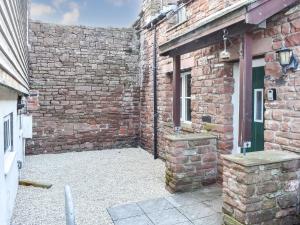 an entrance to a brick building with a window at Drovers Barn in Penrith
