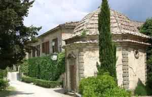 a large stone building with a tree at Villa Castellina - Homelilke Villas in Castellina in Chianti