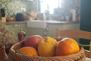a basket of fruit sitting on a table at Erofili cottage house in Elounda