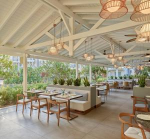 a restaurant with tables and chairs and windows at Lara Barut Collection-Ultra All Inclusive in Lara