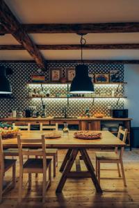 jadalnia ze stołem i krzesłami oraz kuchnia w obiekcie JorJ'Inn w mieście Lentekhi