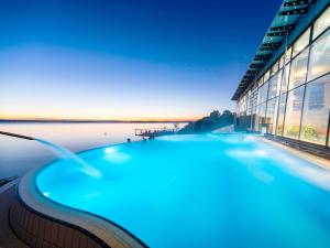 a blue swimming pool in front of a building at Seeperle 4 in Meersburg