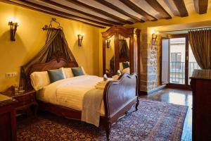 a bedroom with a large bed with a canopy at El Retiro del Obispo in Laguardia