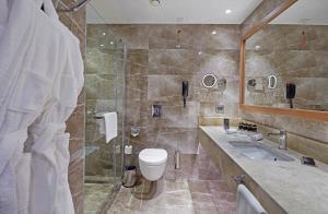 a bathroom with a shower and a toilet and a sink at Dedeman Kayseri in Kayseri