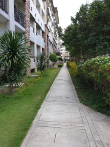 an empty sidewalk in front of a building at Ri's One Oasis w Free Pool back of SM City Mall in Davao City