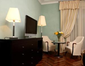 a living room with a television and a lamp at Villa Ersilia in Soverato Marina