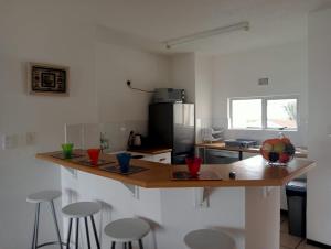 a kitchen with a counter top with stools in it at Laguna La Crete 163 in Margate +1 photo
