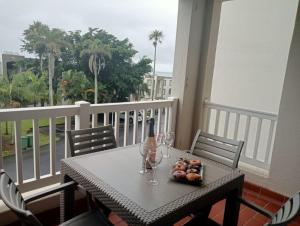 a table with a bottle of wine and glasses on a balcony at Laguna La Crete 163 in Margate