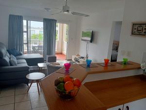 a living room with a table with a bowl of fruit on it at Laguna La Crete 163 in Margate