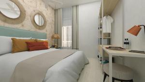 加的斯Apartamentos Soho Boutique Palillero的卧室里有一张床、一张书桌和一面镜子