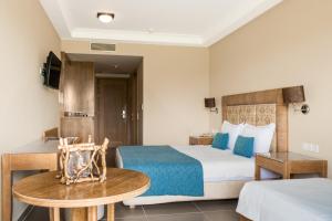 a hotel room with a bed and a table at Danai Hotel & Spa in Olympic Beach