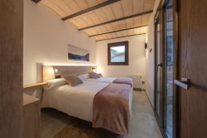 a bedroom with a large bed in a room at Can Sunyer in Camprodon