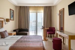 a hotel room with a bed and a desk at Danai Hotel & Spa in Olympic Beach