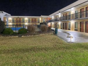 a large apartment building at night with the lights on at Quality Inn Elizabeth City near University in Elizabeth City
