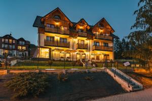 a large house with a pool in front of it at Vena in Szczawnica