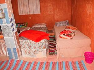 a small room with two beds and a couch at Dar Lhor in Tarhjicht