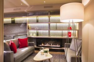 a living room with a couch and a fireplace at Best Western Quartier Latin Pantheon in Paris +19 photos