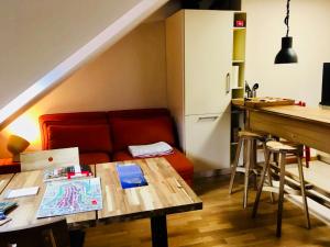 a living room with a red couch and a table at Apartments Aarbergergasse in Bern