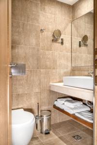 a bathroom with a toilet and a sink at Danai Hotel & Spa in Olympiaki Akti