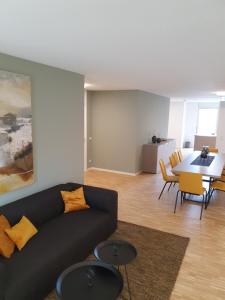 a living room with a couch and a table at Con4rent Business Hotel plus in Kirchheim unter Teck