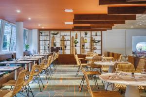 a row of tables and chairs in a restaurant at Belambra Clubs Anglet - La Chambre d'Amour in Anglet