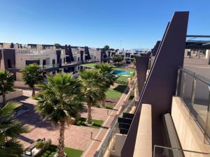 a view of a city with palm trees and buildings at Apto Higuericas playas in Pilar de la Horadada