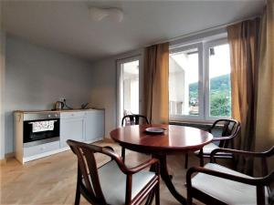 a dining room with a table and chairs and a window at Apartament u Tomka Premium in Ustrzyki Dolne